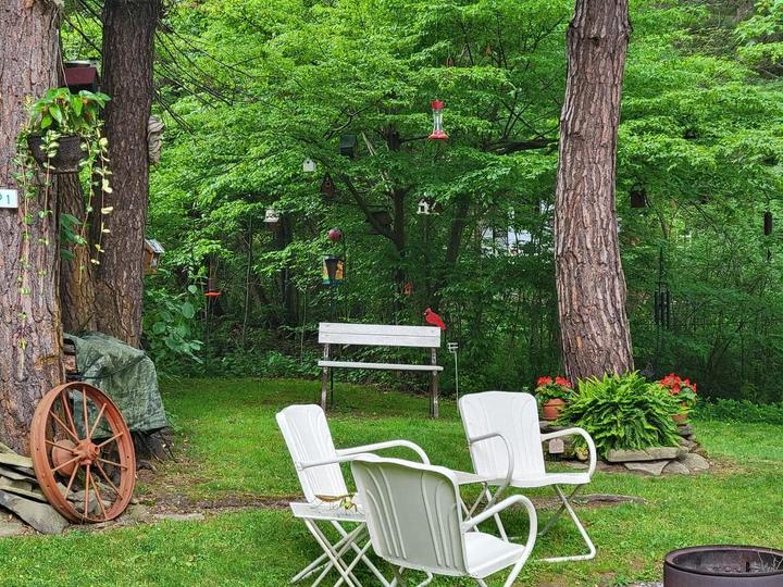 White garden chairs on a landscaped campsite