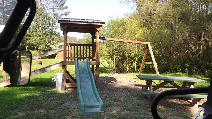 Wooden playground with a slide and swings